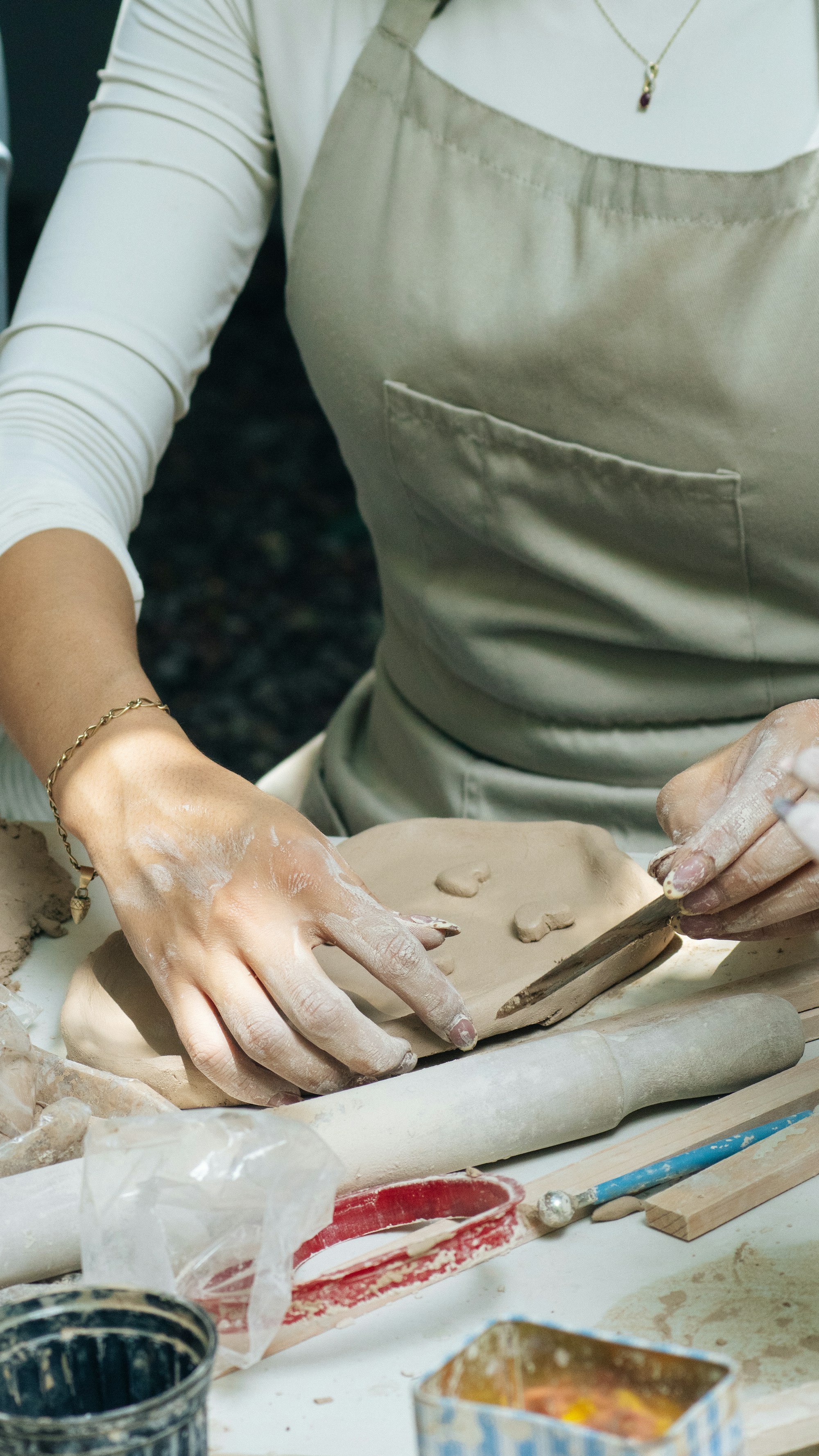 Hands shaping clay